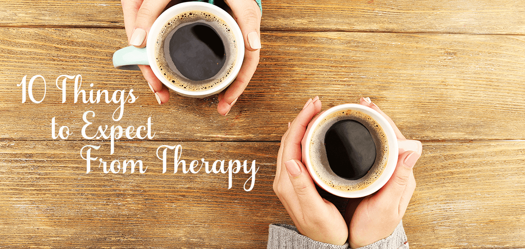 10 Things to Expect From Therapy: two people holding coffee mugs across a wooden table