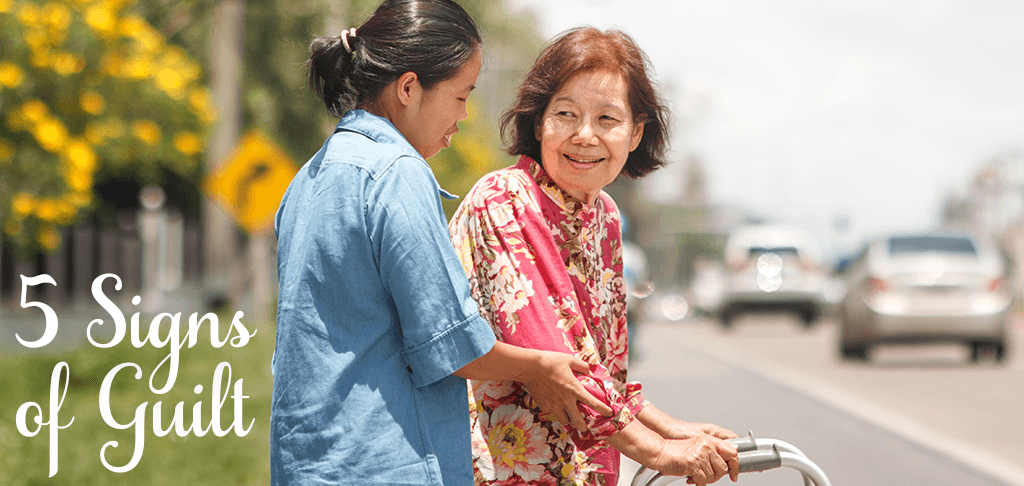 5 Signs of Guilt: a young woman helps an older woman with a walker along a sidewalk